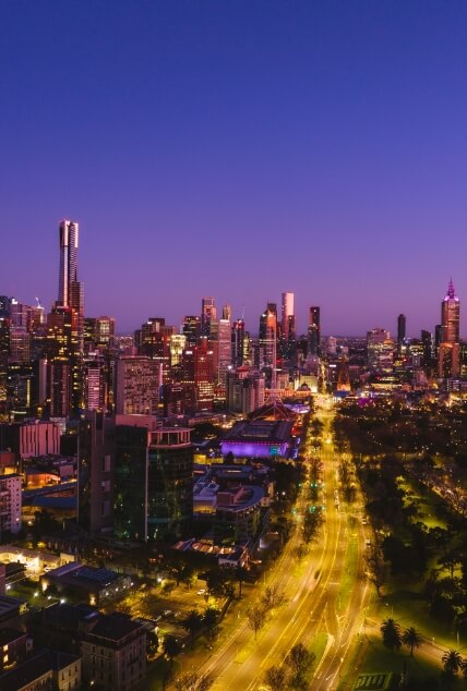 A stunning aerial shot of Melbourne's skyline at twilight, showcasing the city's vibrant energy and modern architecture.